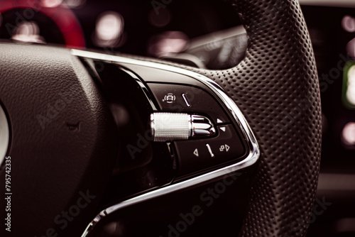 Many buttons and connections on a steering wheel of a modern car photo