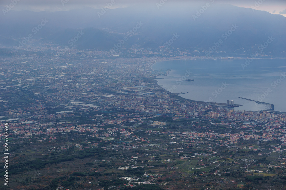 View from the top of Mount Vesuvius down to the city of Pompeii on a hazy winter day, Naples, Campania, Italy