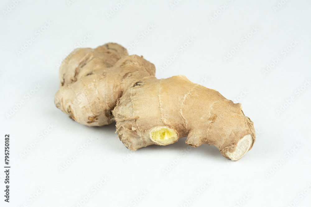 Raw fresh uncut ginger root on white background
