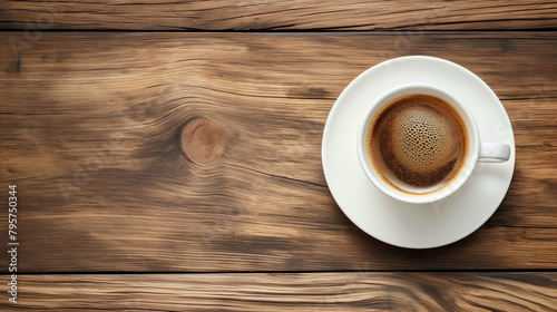 Top view of cup of coffee on wooden table