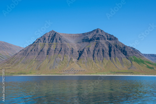 Kirkjubolsfjall mountain seen from the cast of Holtsfjara in Onundarfjordur in Iceland photo