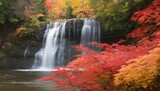 A cascading waterfall framed by vibrant autumn fol
