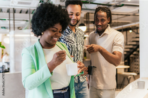 Diverse team enjoying a coffee break in a modern coworking space photo