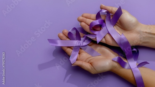 Hands holding purple ribbon, world cancer day february 4th, on purple flat lay. World Lupus Day © Ahtesham
