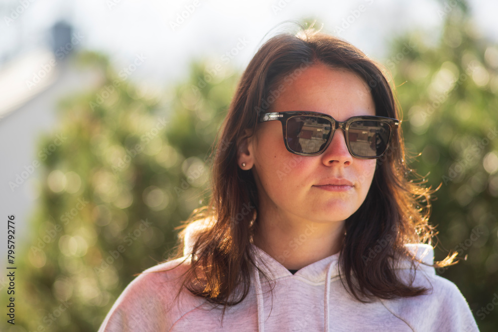 Portrait of a beautiful young woman with dark hair and sunglasses. Portrait of a beautiful young woman with dark hair and sunglasses.