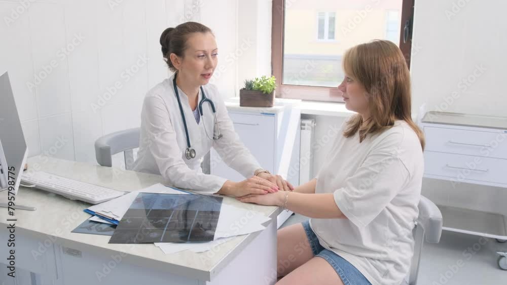 Compassionate Doctor Consults With Female Patient in Bright Clinic Compassionate Doctor Consults With Female Patient in Bright Clinic