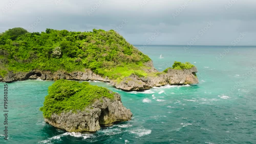 Beautiful sea waves crashing on rocks and islets under cloudy sky. Boracay, Philippines. Beautiful sea waves crashing on rocks and islets under cloudy sky. Boracay, Philippines.