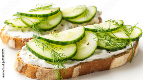 Open cucumber sandwiches with cream cheese and dill on whole grain bread, isolated on white.