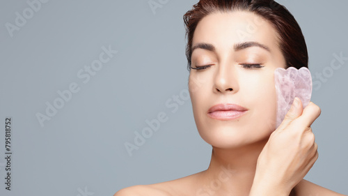 Woman Using Gua Sha for Facial Rejuvenation and Skincare