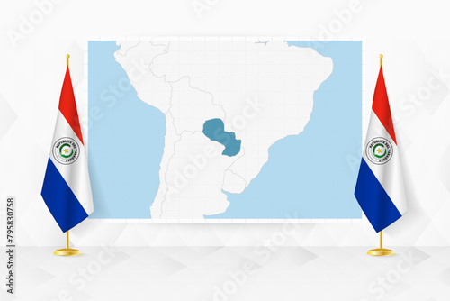 Map of Paraguay and flags of Paraguay on flag stand.