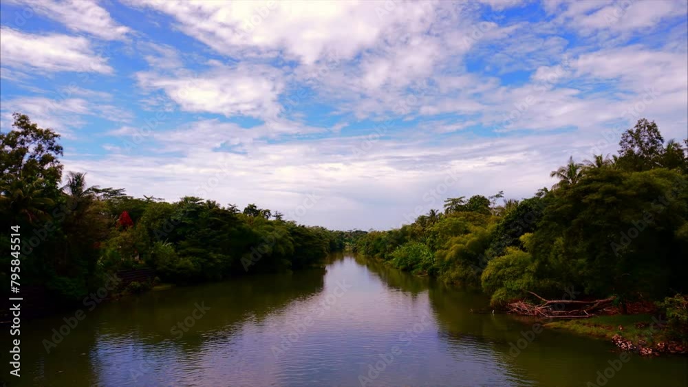 Timelapse view of the Kali Jali river in Indonesia. beautiful movement of clouds and water Timelapse view of the Kali Jali river in Indonesia. beautiful movement of clouds and water