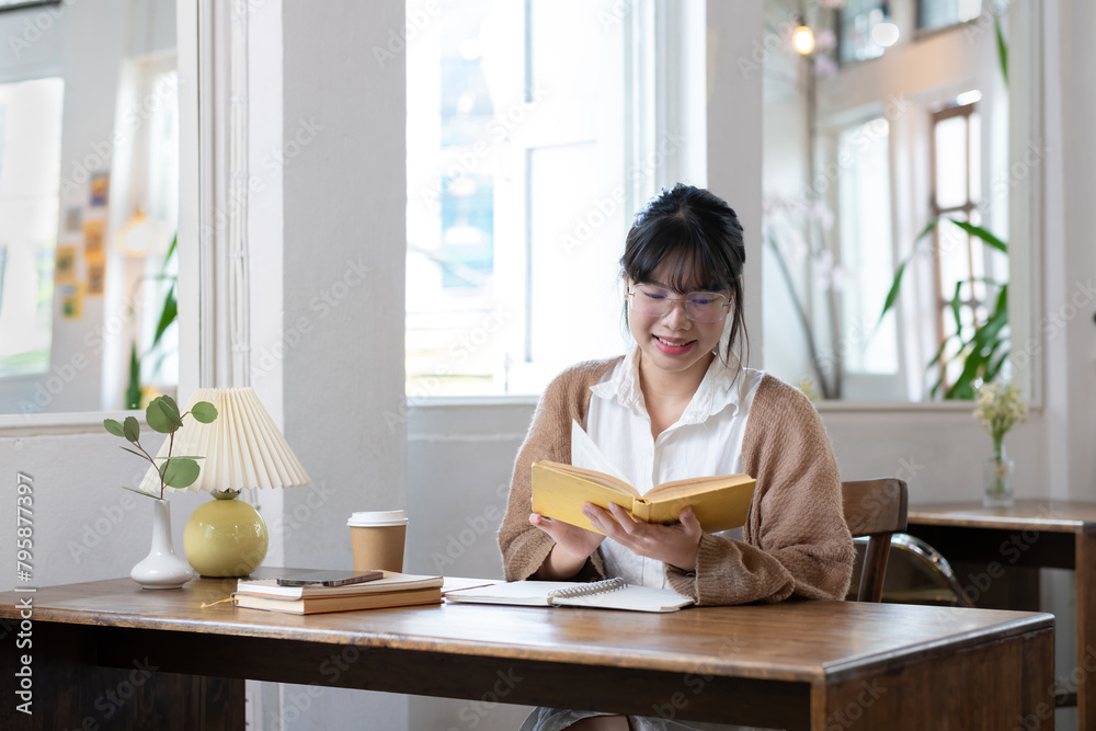 Asian students study online, take notes, do homework, study online from home on a wooden table in the house. Asian students study online, take notes, do homework, study online from home on a wooden table in the house.