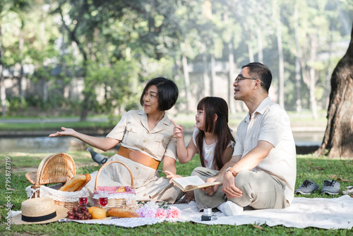 warm family There are parents and children doing picnic activities and relaxing outside together at the park on holidays.