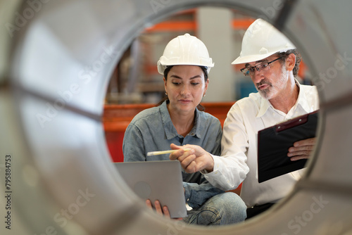 Wallpaper Mural two professional engineer,worker,technician use clipboard discuss work, walk in steel metal manufacture factory plant industry. Black African American man and woman wear hard hat check quality machine Torontodigital.ca