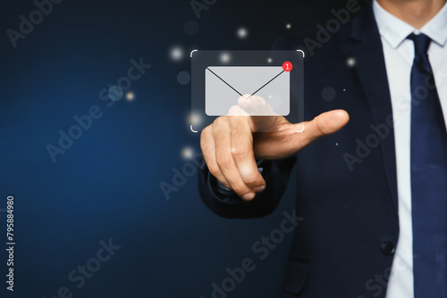 Email. Man touching virtual screen with incoming letter notification against dark blue background, closeup