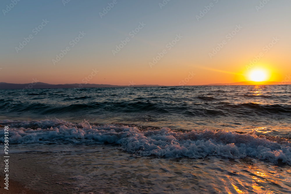 Sea waves on the golden sand at beach. Beautiful tropical nature beach sea ocean with sunset or sunrise for travel vacation