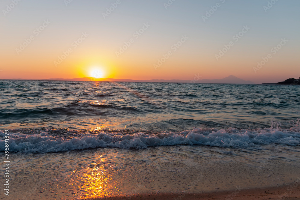 Sea waves on the golden sand at beach. Beautiful tropical nature beach sea ocean with sunset or sunrise for travel vacation