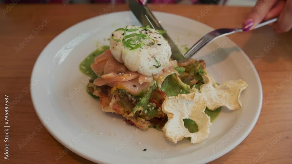 Potato waffle with salmon, poached egg in spinach sauce on white plate. Potato waffle with salmon, poached egg in spinach sauce on white plate.