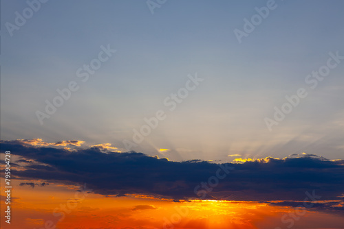 Sunset sky with clouds and sun ray. Beautiful nature background.