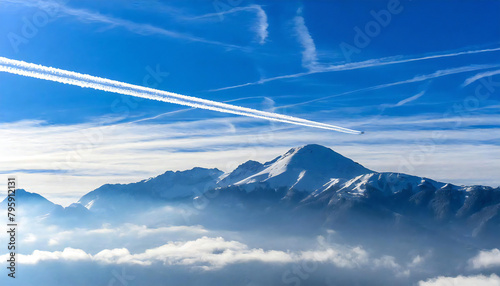 Airplanes and contrails. Blue sky background. A single contrail. photo