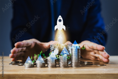 A man is holding a stack of coins and a rocket