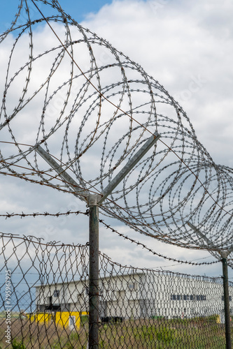 Barbed wire fence. Razor wire. Restricted area. Airport protection.