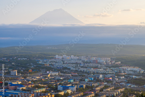 Morning cityscape. Top view of the buildings and streets of the city. Residential urban areas at sunrise. Koryaksky volcano in the distance. Petropavlovsk-Kamchatsky, Kamchatka Krai, Russian Far East. photo