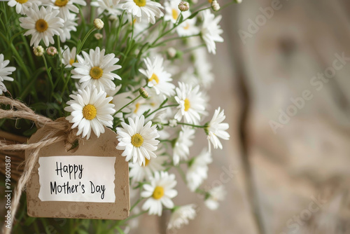 A bouquet of white flowers with a tag that says Happy Mother's Day