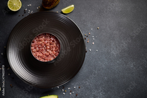 Tuna and avocado tartare recipe - cooking form with sliced chopped tuna fillet photo