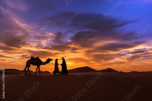 Silhouette of camel and man in arabian dress with woman against sunset sky background  beautiful desert landscape