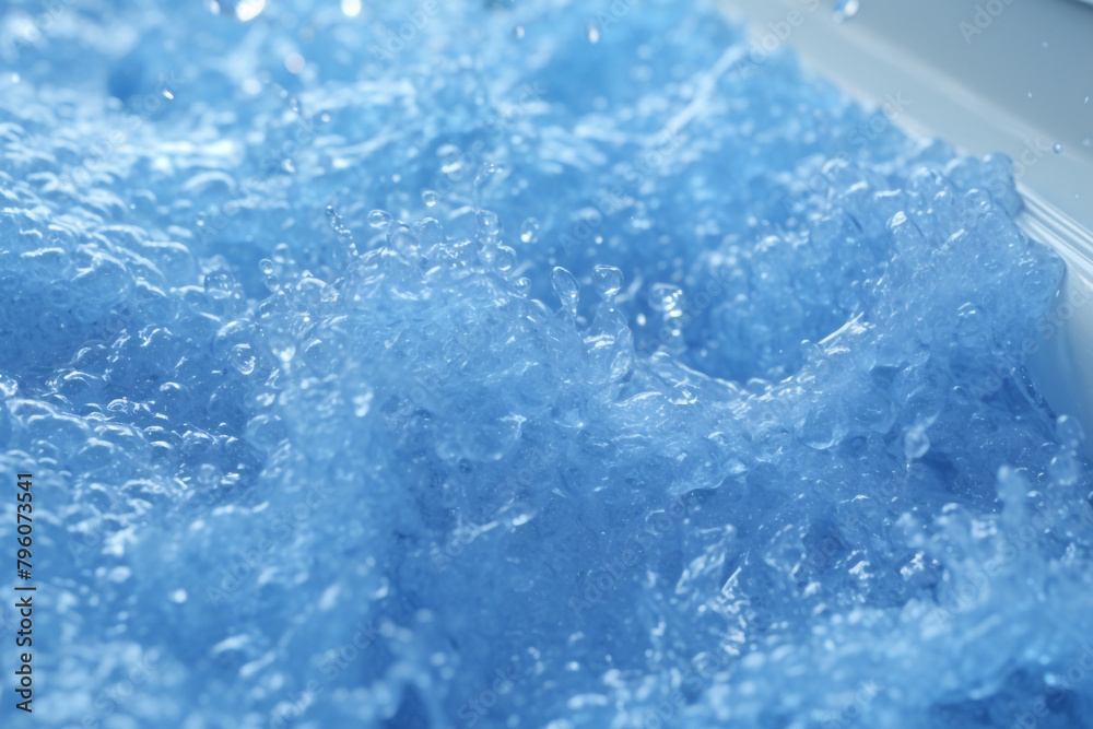 A detailed image capturing the movement and texture of bubbling blue water A detailed image capturing the movement and texture of bubbling blue water