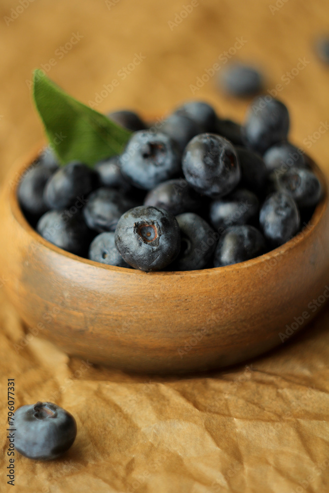 blueberries in a wooden bowl blueberries in a wooden bowl