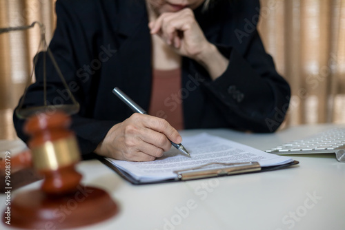 female lawyer at workplace with documents and laptop in office