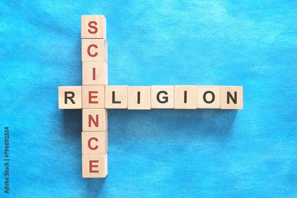 Science and religion relationship and interconnection concept. Crossword puzzle flat lay in blue background.