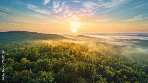 The top view picture of the wild nature that fills with green forrest  great mountain  cloudscape  blue sky  and the sun in the bright morning day in the summer or spring time of the years. AIGX01.