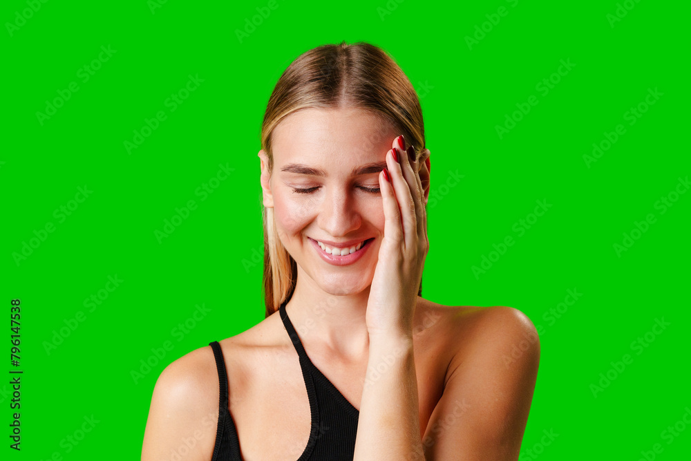 Smiling Young Woman in Casual Outfit Posing Against Green Background Smiling Young Woman in Casual Outfit Posing Against Green Background
