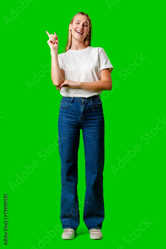 Young Woman Pointing Up Against Green Background