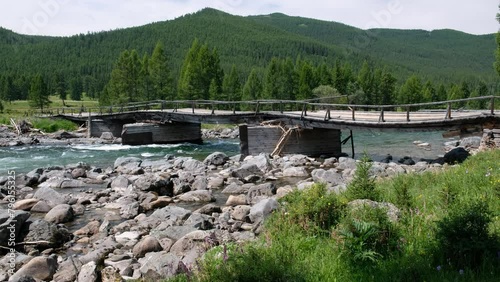 Video of old wooden bridge over Altai river Bashkaus. photo