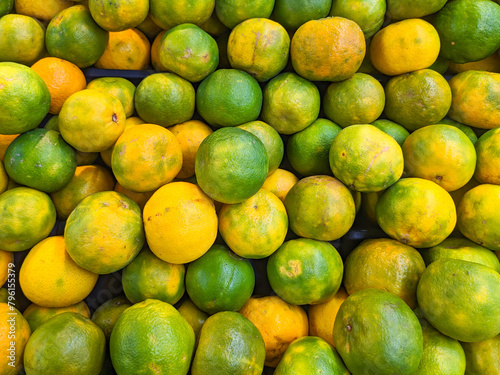 Orange fruit on the counter in the supermarket. Backgrounds and textures