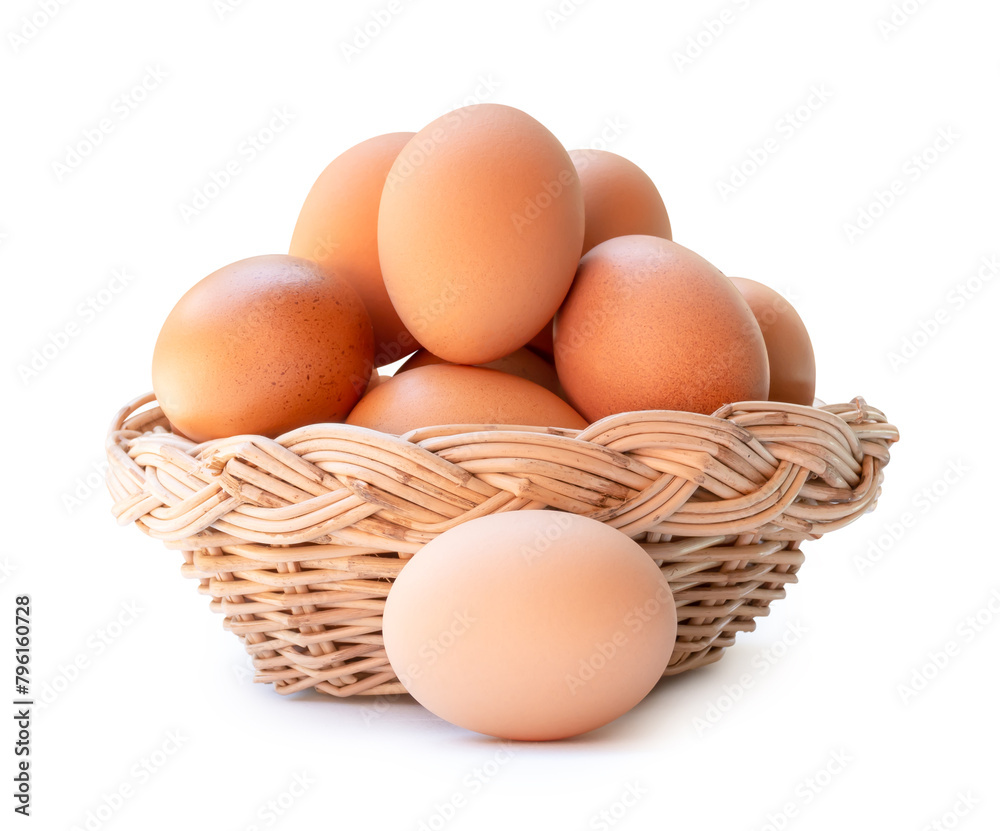 Front view of fresh brown chicken eggs in stack in wicker basket isolated on white background with clipping path