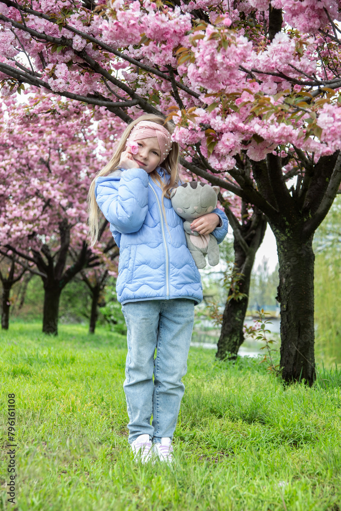 portrait of a little girl in pink cherry blossoms portrait of a little girl in pink cherry blossoms