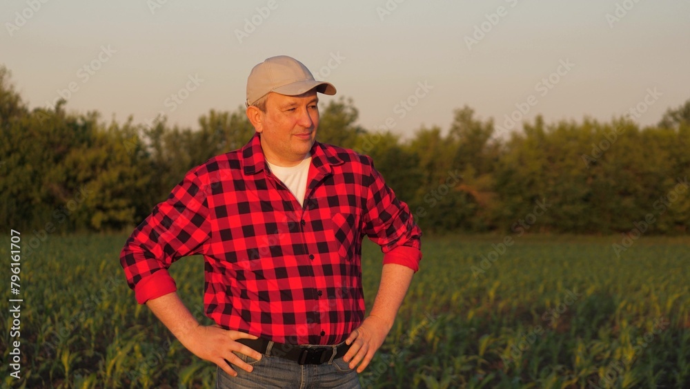Portrait smiling man farmer posing at sunset sunny corn field countryside nature closeup. Male agronomist agricultural worker standing maize plantation organic harvest cultivation tree sky landscape