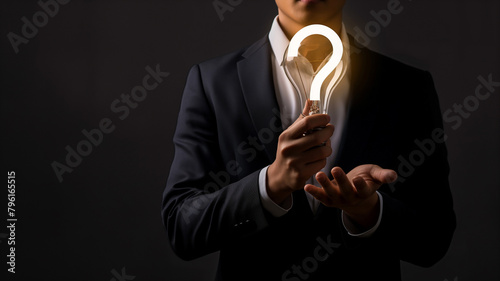 Business concept. The employee answers frequently asked questions about the company. Manager holding light bulb and question mark. Customer relations answers questions.