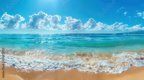 A wide shot of the turquoise ocean and sandy beach, with gentle waves lapping at the shore in Hawaii on a sunny day