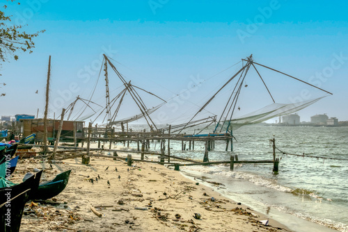 fishing with fishing nets on a wooden scaffold at the sea in Cochin, Kerala, India