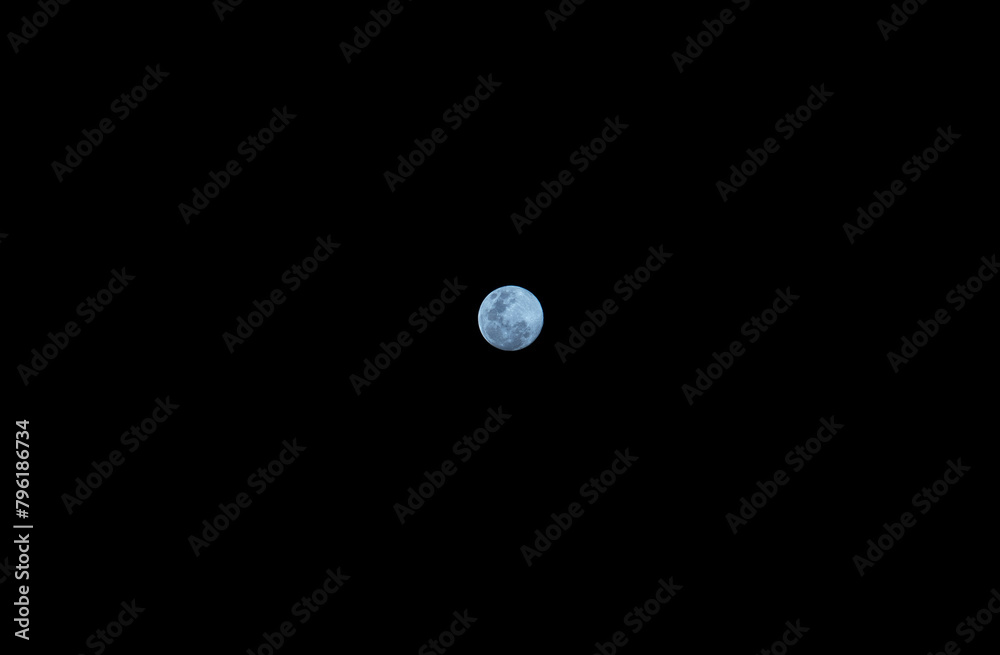 Small blue moon in the sky and black background Small blue moon in the sky and black background