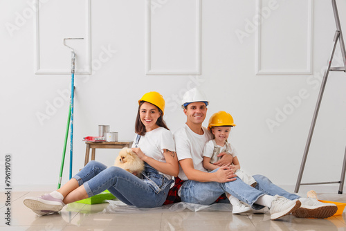 Happy family in hardhats si...