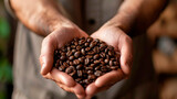A male farmer holds roasted coffee beans in his palms, close-up.