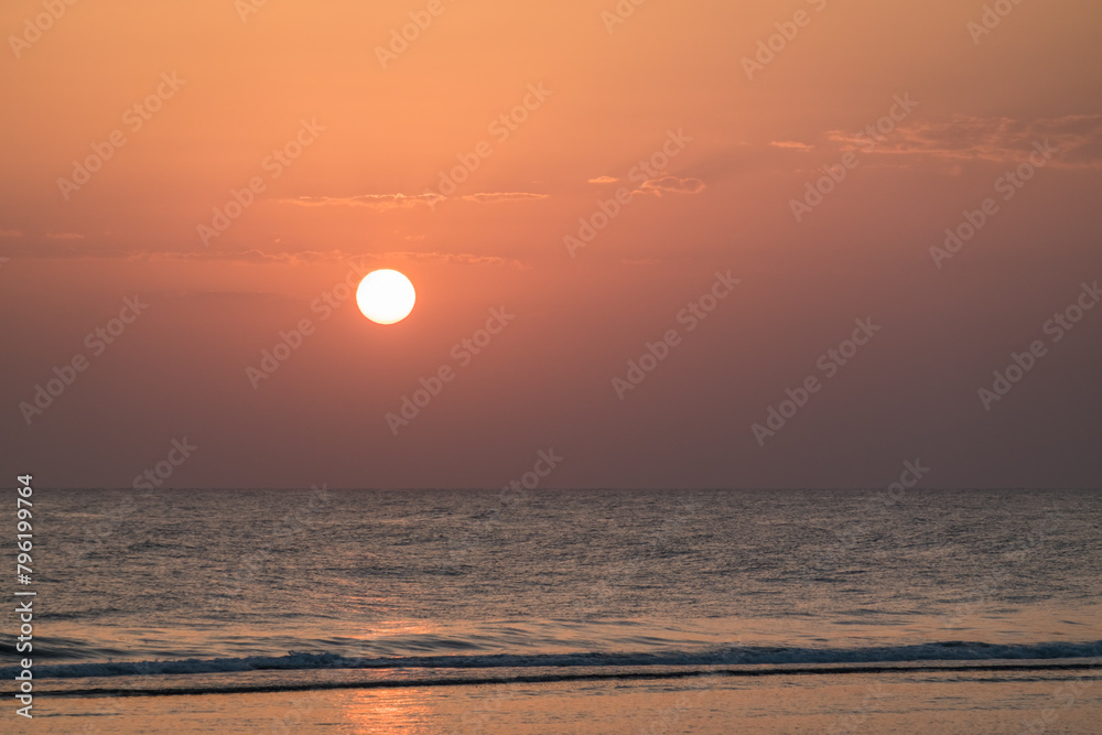 warm bright white sun with little clouds during sunrise