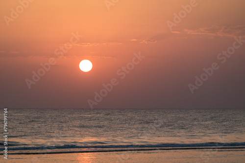 warm bright white sun with little clouds during sunrise